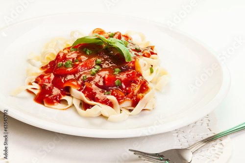 Pasta fettuccine with tomato sauce and basil