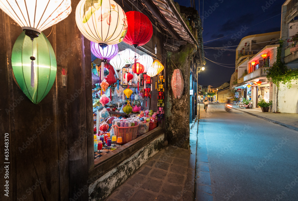 Shop with big window and colorful lanterns.
