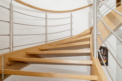 Curved wooden staircase with stainless steel elements