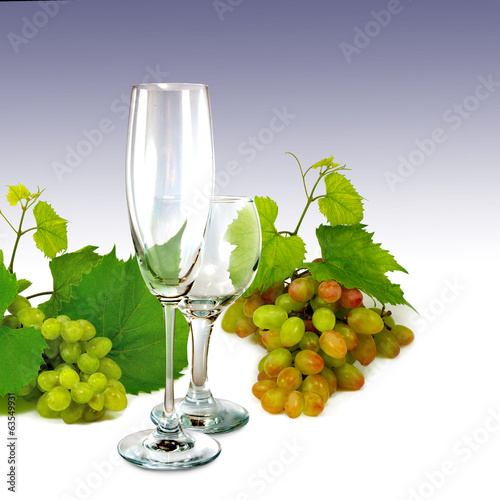 grapes and two empty glasses on purple background