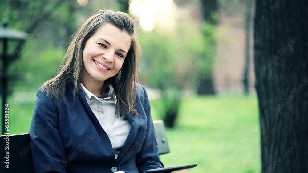 Happy attractive businesswoman with tablet computer in park Happy attractive businesswoman with tablet computer in park