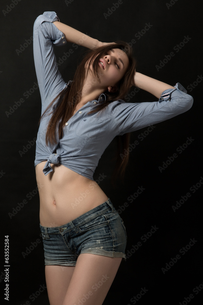 Young model posing over dark background Young model posing over dark background