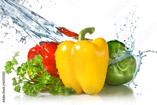 red  yellow  green pepper and parsley with water splash isolated