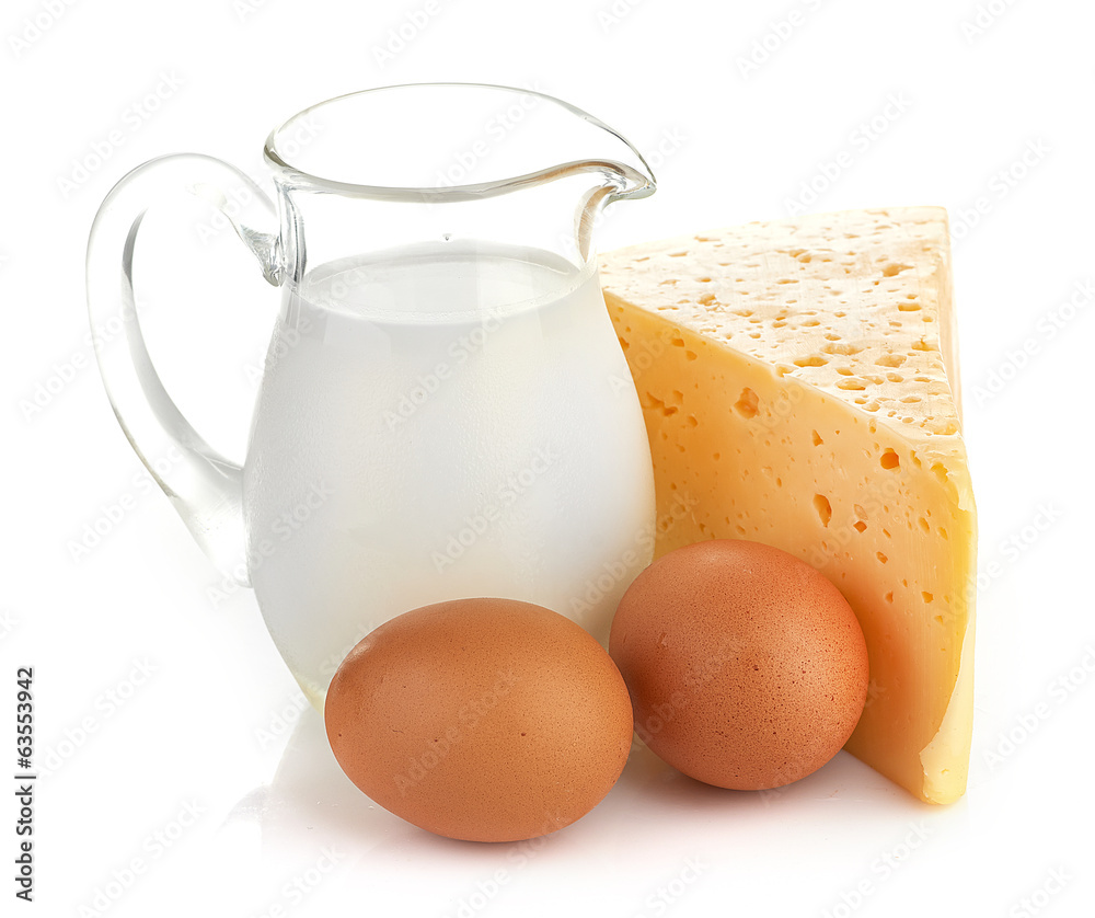 Big piece of cheese, glass jug with milk Big piece of cheese, glass jug with milk