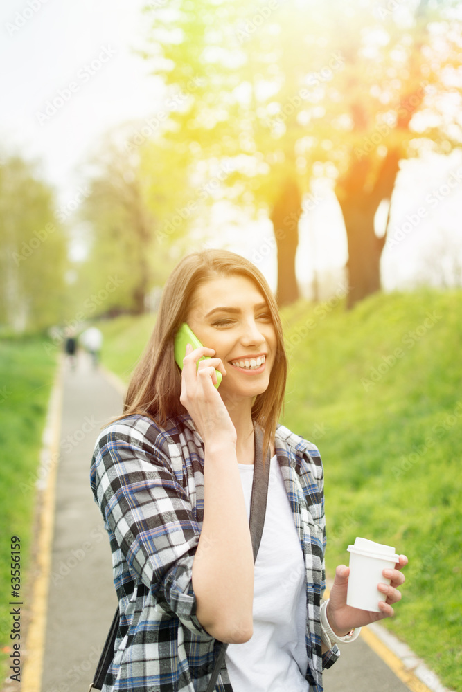 Beautiful young woman talking on the phone laughing Beautiful young woman talking on the phone laughing