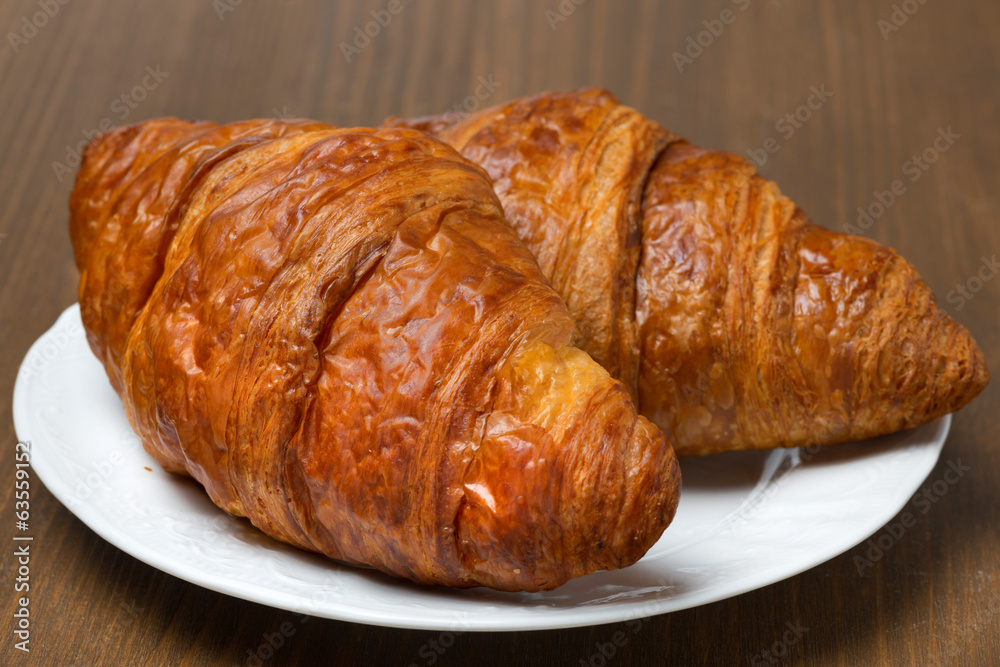 fresh croissants on a plate, close-up fresh croissants on a plate, close-up