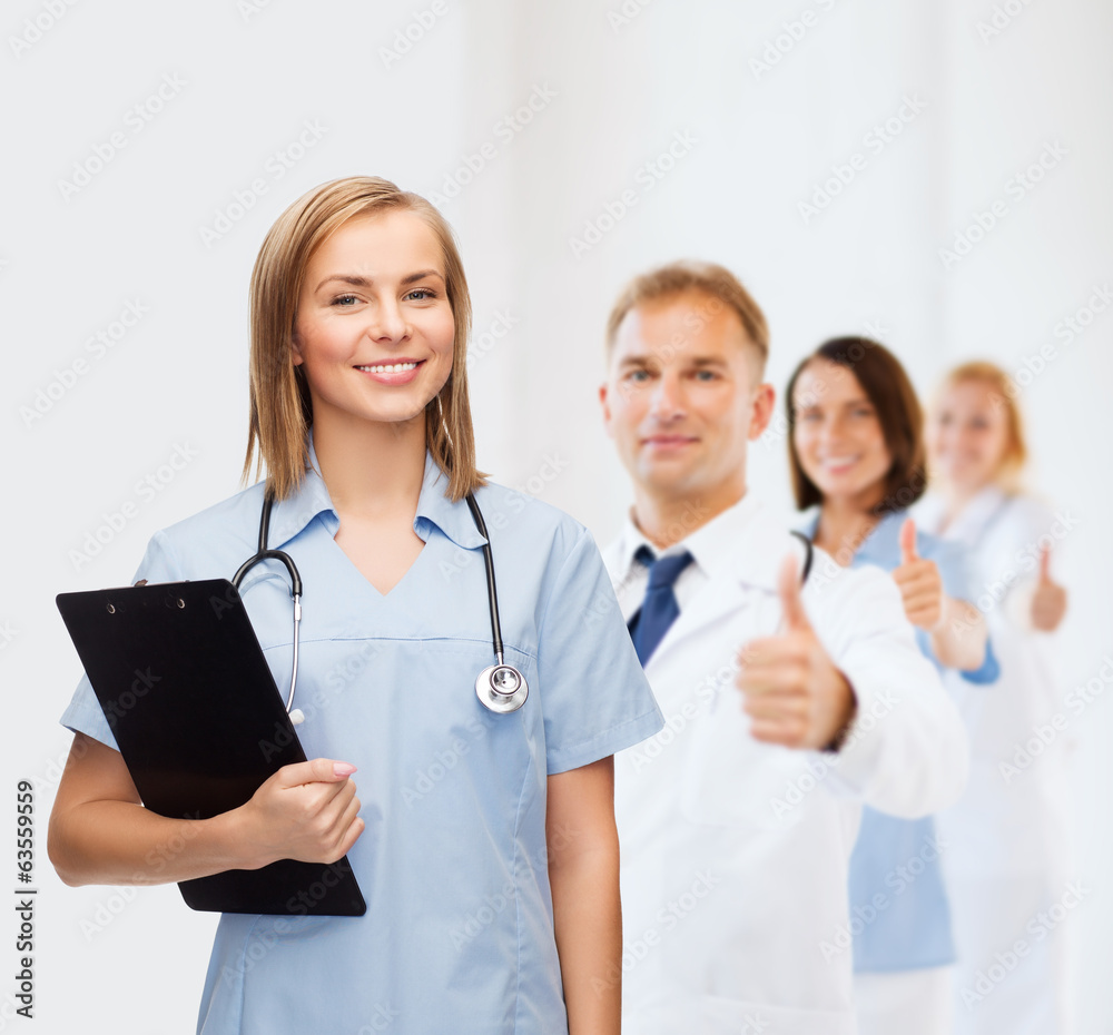 smiling female doctor or nurse with clipboard smiling female doctor or nurse with clipboard
