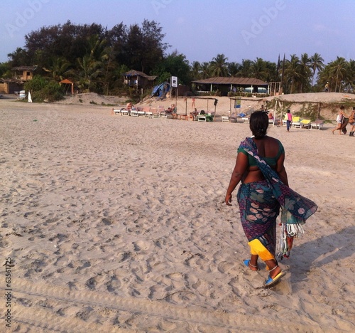 indian woman walking on the beach