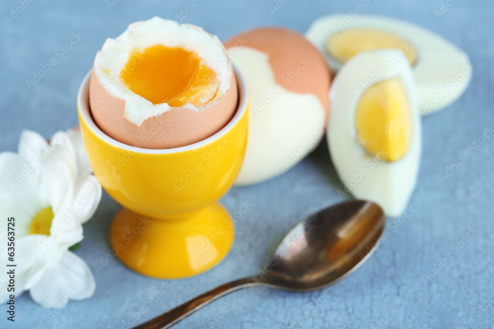 Boiled eggs on color wooden background - obrazy, fototapety, plakaty 