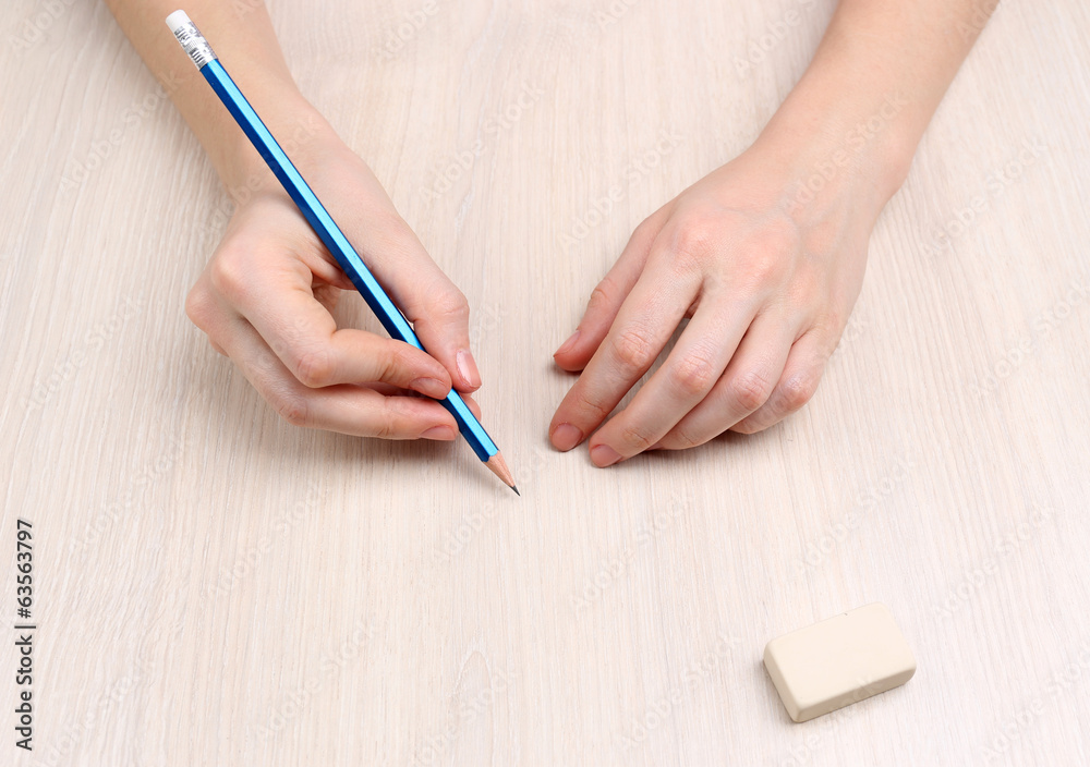Human hands with pencil and erase rubber Human hands with pencil and erase rubber