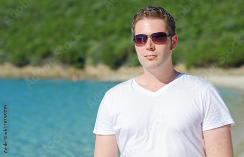 Attractive young man on tropical beach.