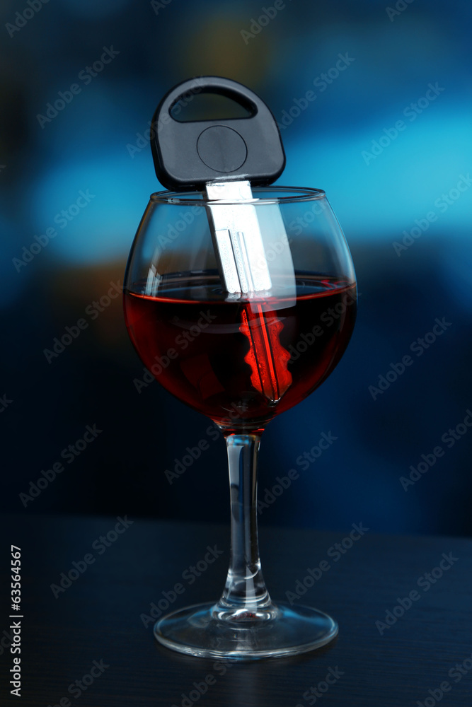 Composition with car key and glass of red wine,