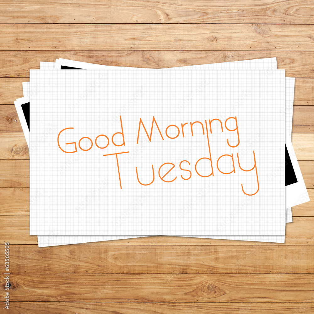 Good Morning Tuesday on paper and Brown wood plank background Good Morning Tuesday on paper and Brown wood plank background