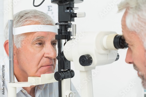 Optometrist doing sight testing for senior patient