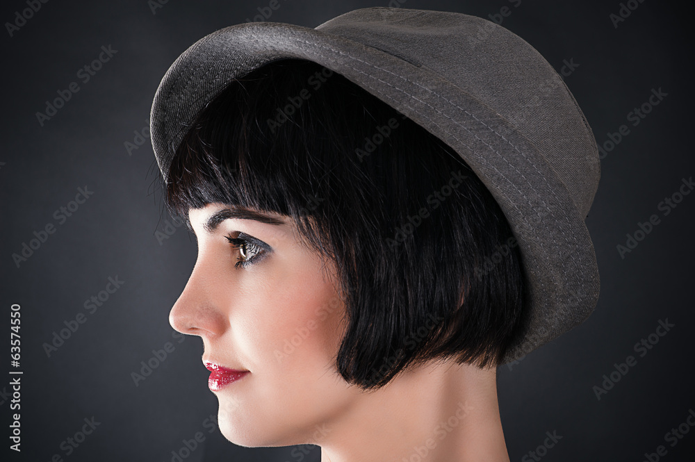 profile of a face of a beautiful woman in a male hat profile of a face of a beautiful woman in a male hat