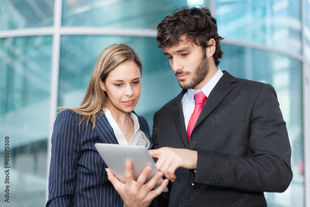 Business people using a digital tablet Business people using a digital tablet