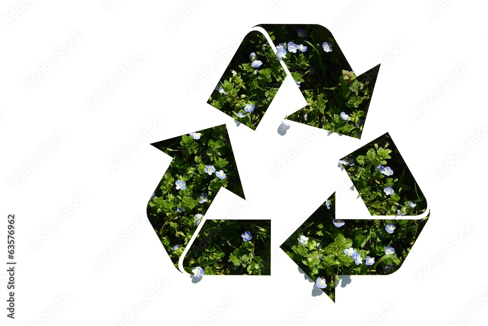 recycle symbol on grass and flowers recycle symbol on grass and flowers