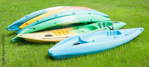 Colorful Kayaks Resting on Bright Green Grass
