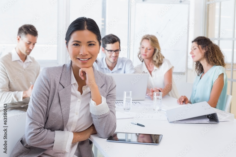 Casual businesswoman smiling at camera during meeting Casual businesswoman smiling at camera during meeting