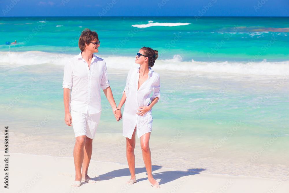 portrait of happy young couple in sunglasses in white clothes portrait of happy young couple in sunglasses in white clothes