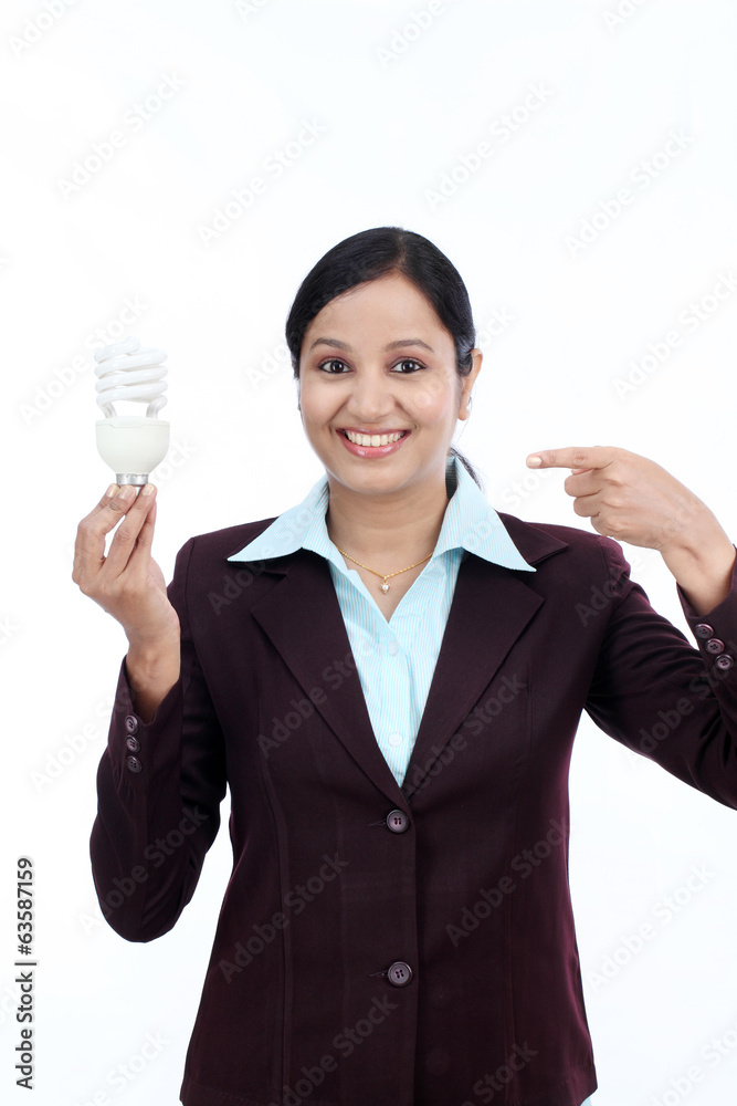 Young Indian business woman holding bulb Young Indian business woman holding bulb