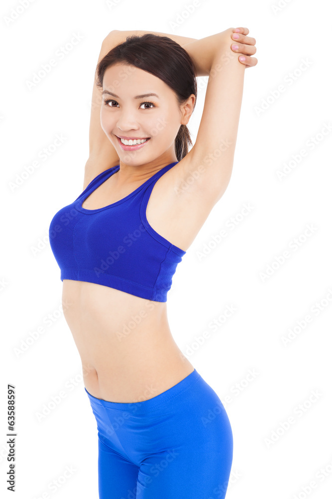 Beautiful fit woman stretching her arm and smiling Beautiful fit woman stretching her arm and smiling