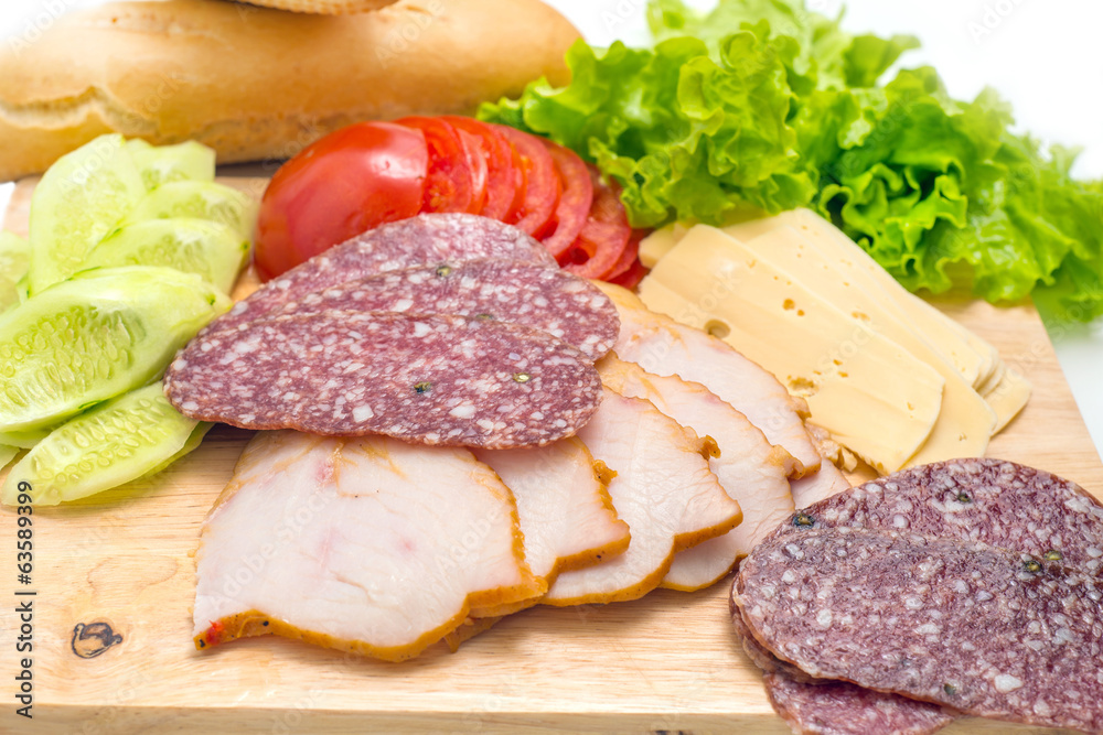 Sandwich ingredients on a wooden board against white background Sandwich ingredients on a wooden board against white background