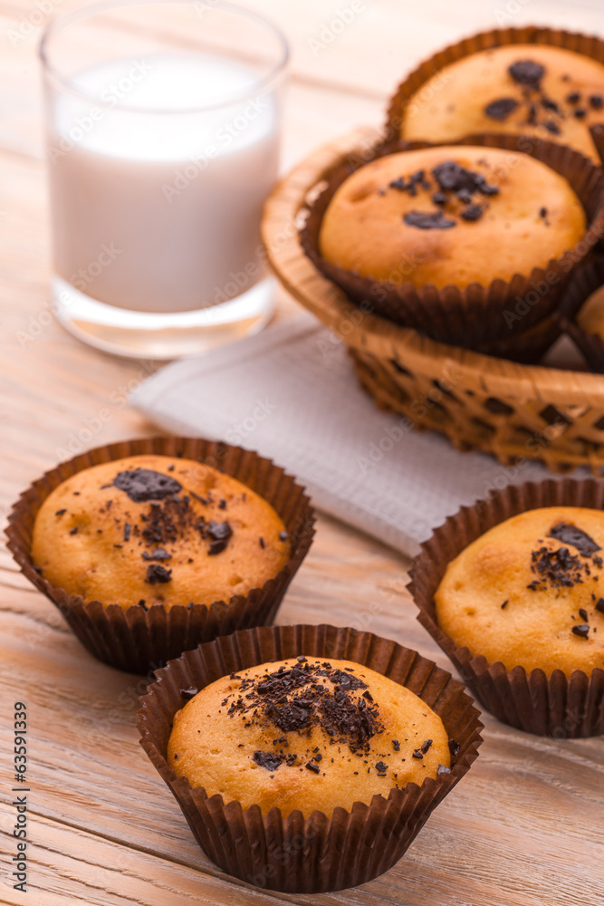 tasty muffins with milk on the light  table