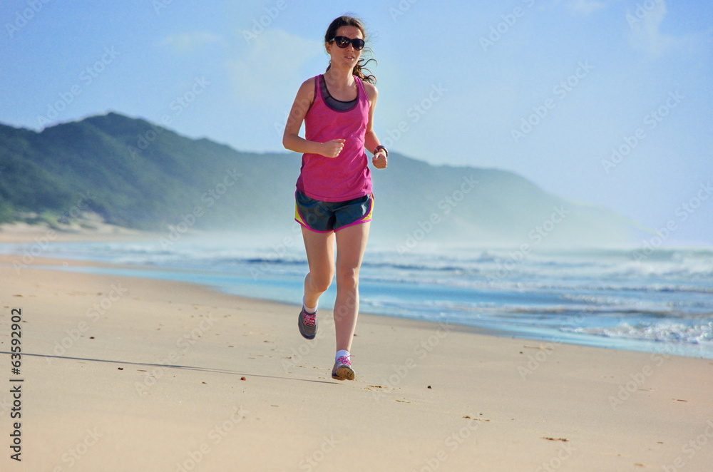 Woman running on beach, beautiful girl runner jogging outdoors Woman running on beach, beautiful girl runner jogging outdoors