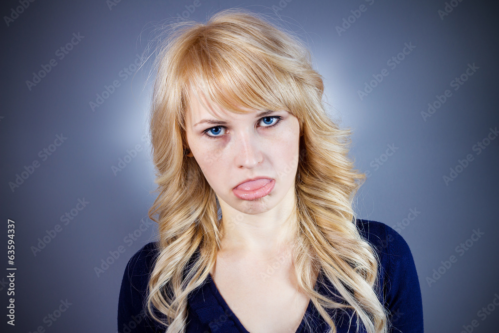Annoyed, tired woman sticking her tongue out Annoyed, tired woman sticking her tongue out
