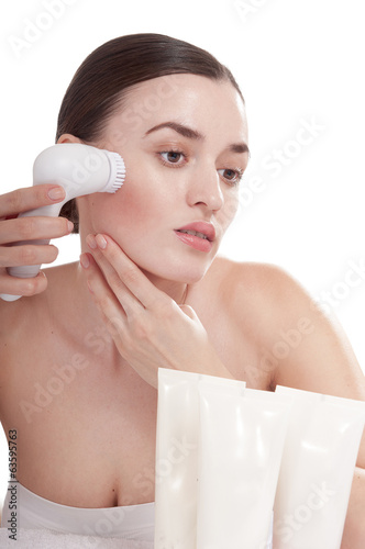 Woman with brush for deep cleansing facial. Skin care concept. photo