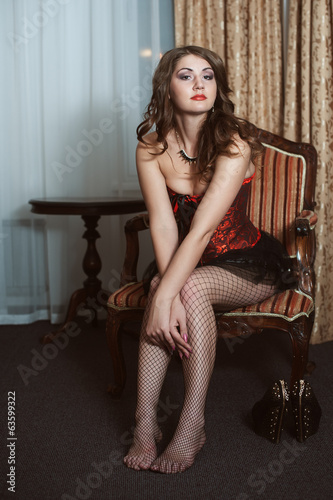 Beautiful sexy woman sitting on chair