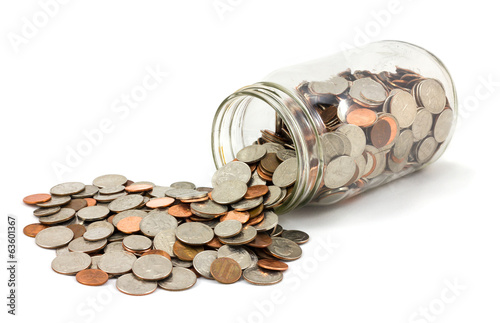 Obraz na płótnie Jar of Coins Spilled on White Background w salonie