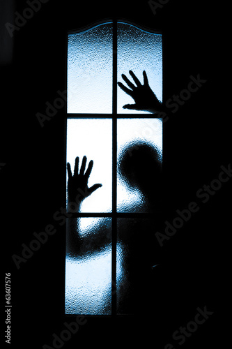 Scared boy behind glass door © fotomaximum