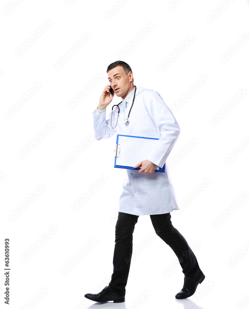 Panicked male doctor running over white background