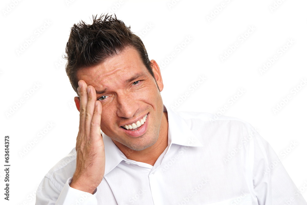 Angry handsome man in white shirt has a headache Angry handsome man in white shirt has a headache