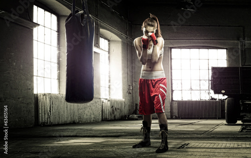 Young woman boxing workout in an old building