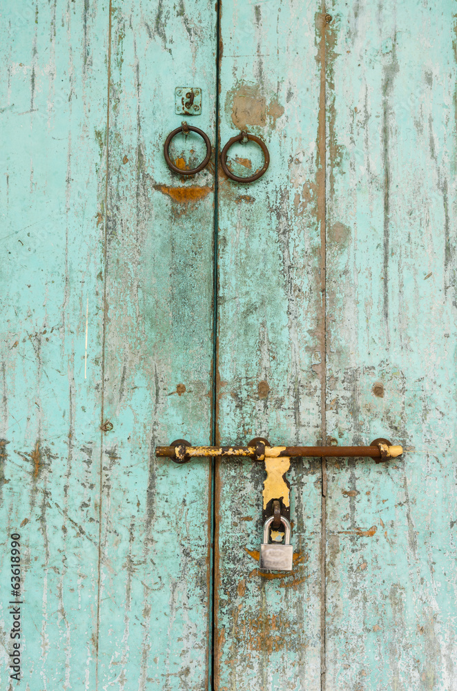an old wood door with metal handle an old wood door with metal handle