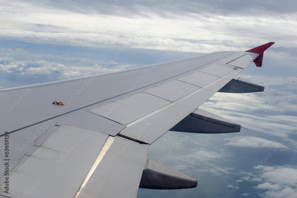 View from a jet plane window high on the blue skies