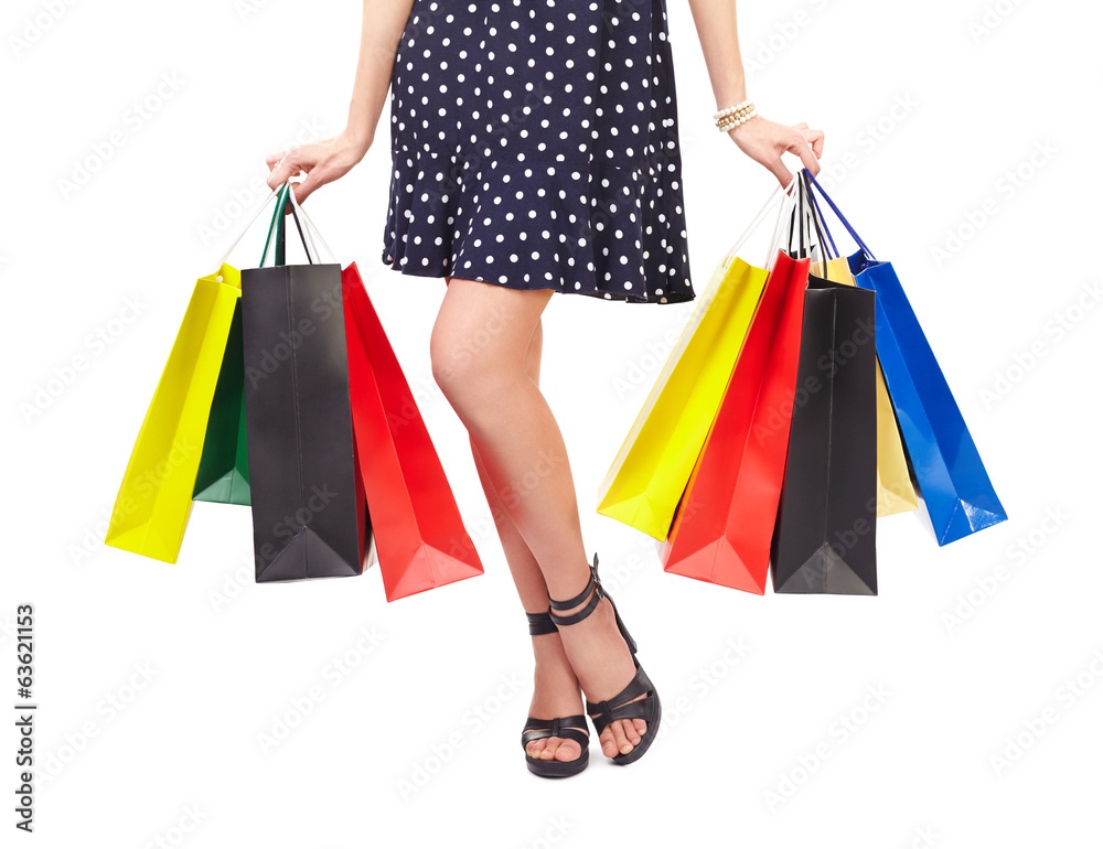 Waist-down view of woman with shopping bags