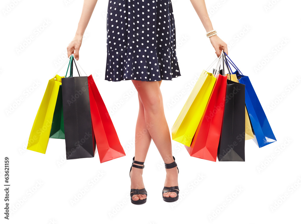 Waist-down view of woman with shopping bags