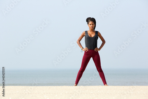 Young woman exercising at the beach