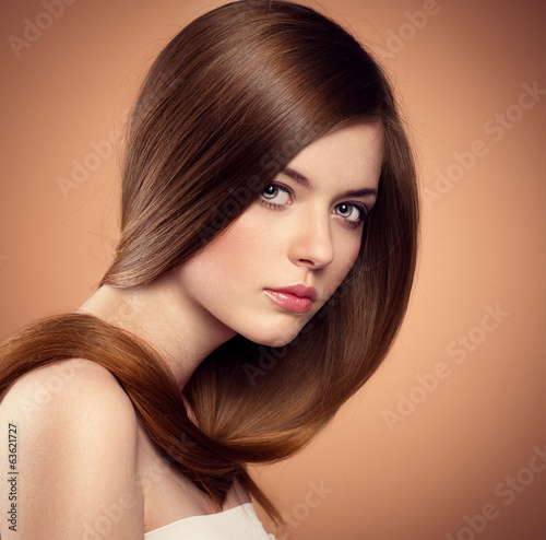 Gentle tenage girl showing her healthy long straight hair