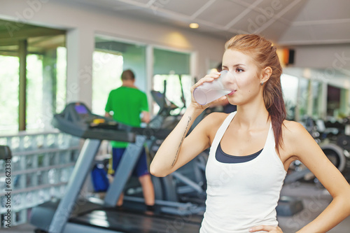 woman in gym having a glass of water