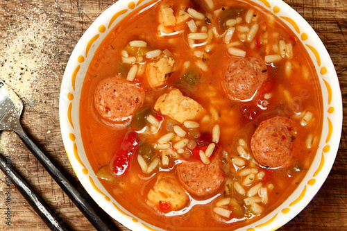 Obraz na plátne Spicy Cajun Chicken and Sausage Rice Gumbo on Table