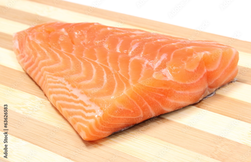 Closeup of salmon steak on wooden background Closeup of salmon steak on wooden background