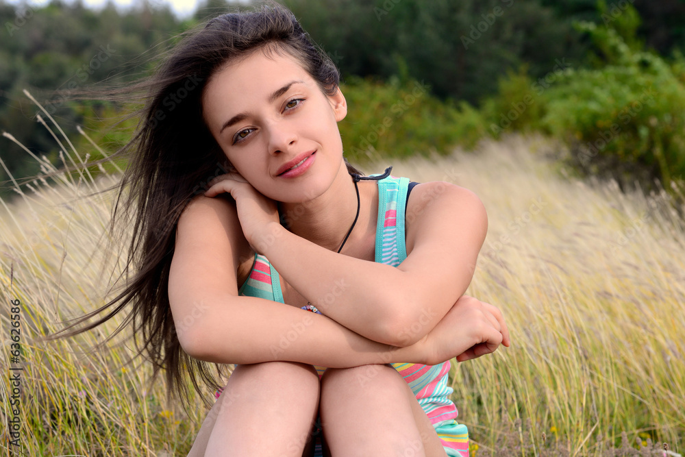Beautiful Young Woman Sitting On Dry Grass Beautiful Young Woman Sitting On Dry Grass