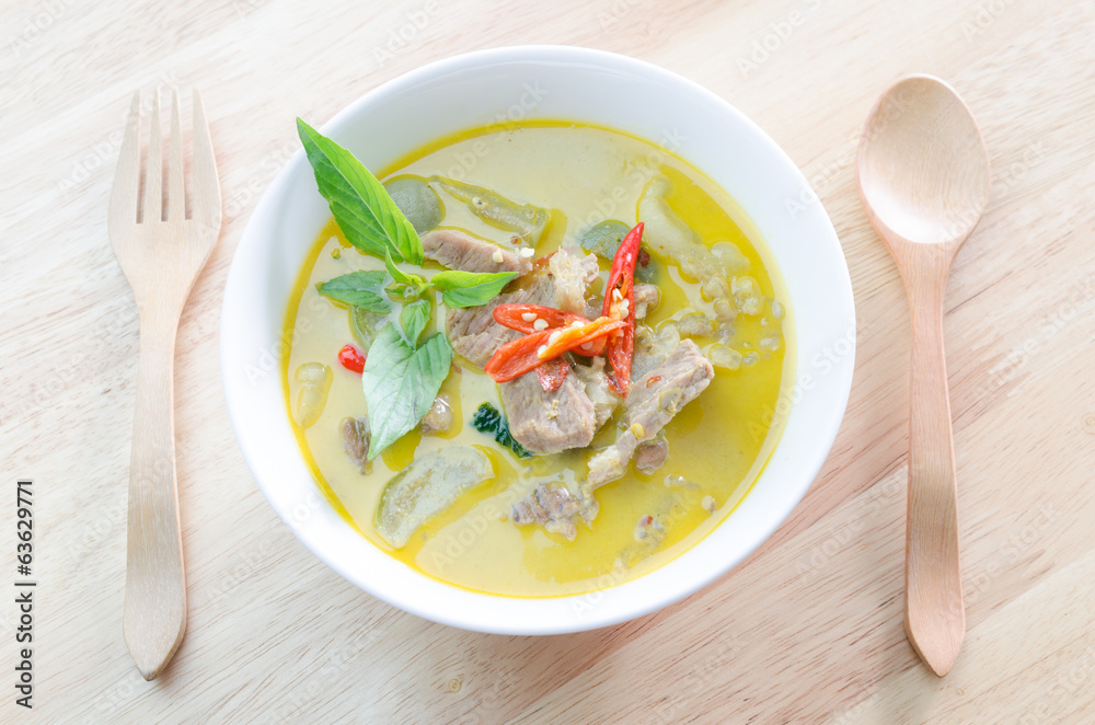 Green curry with pork and woodden fork spoon Green curry with pork and woodden fork spoon