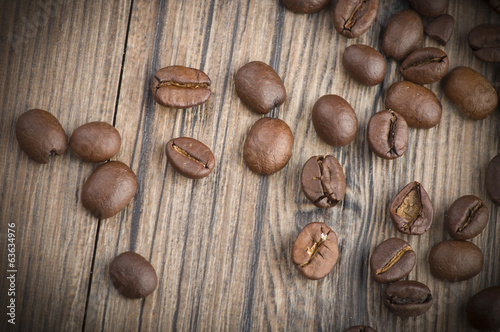 Coffee beans and leaves on the wood table