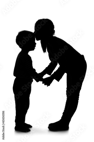 Silhouette of little girl and boy